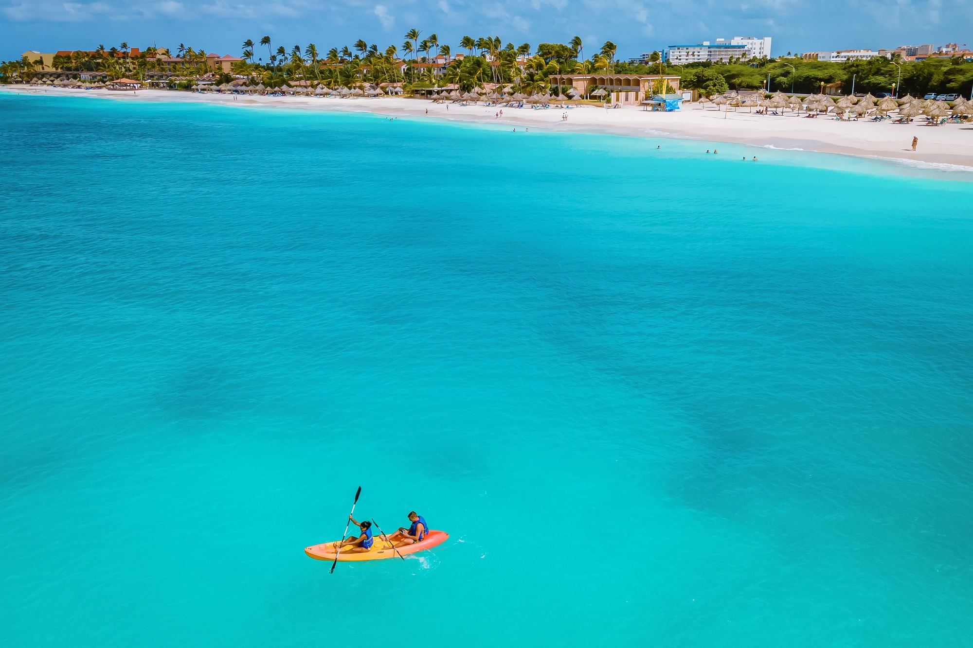 Couple Kayaking in the Ocean on Vacation Aruba Caribbean sea, man and woman mid age kayak in ocean